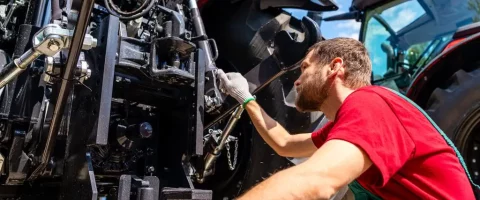 Stock image Agricultural machinery mechanic checking farm tractor
