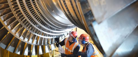 Workers inspect turbine in power station